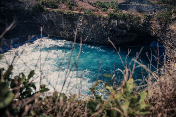 Turquoise water breaking into a rocky cove