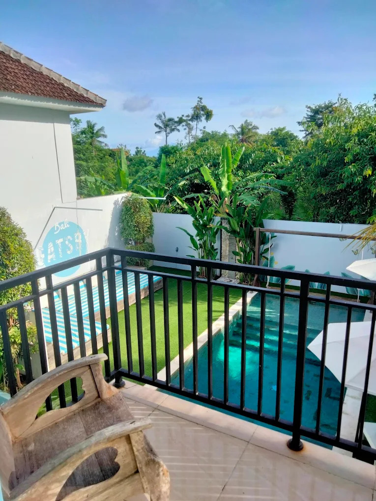 Balcony view over the pool and tropical greenery