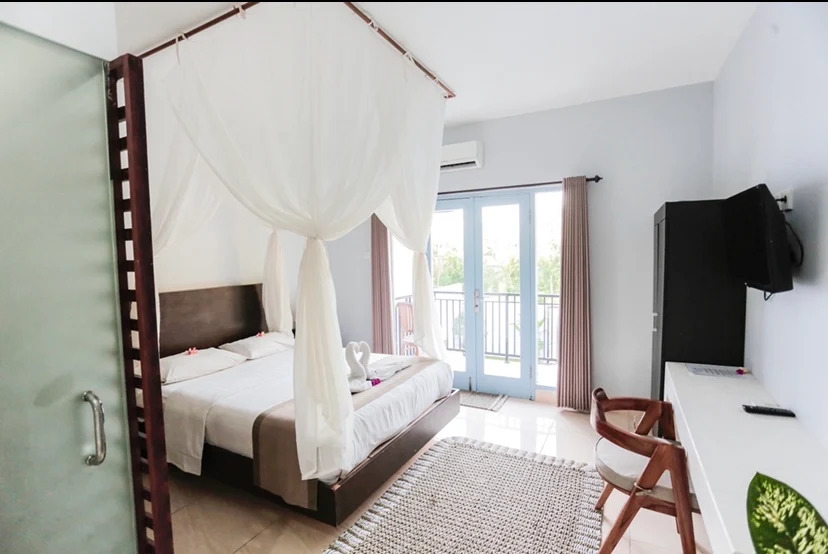 Bright bedroom with a canopy bed draped in white gauze