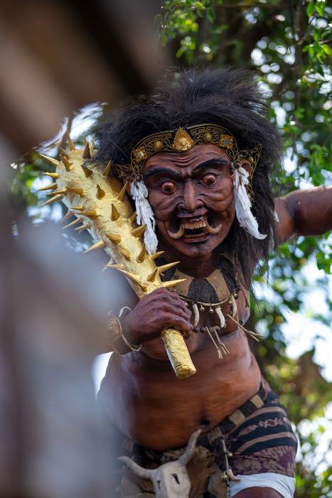 Masked Barong performer holding a golden club