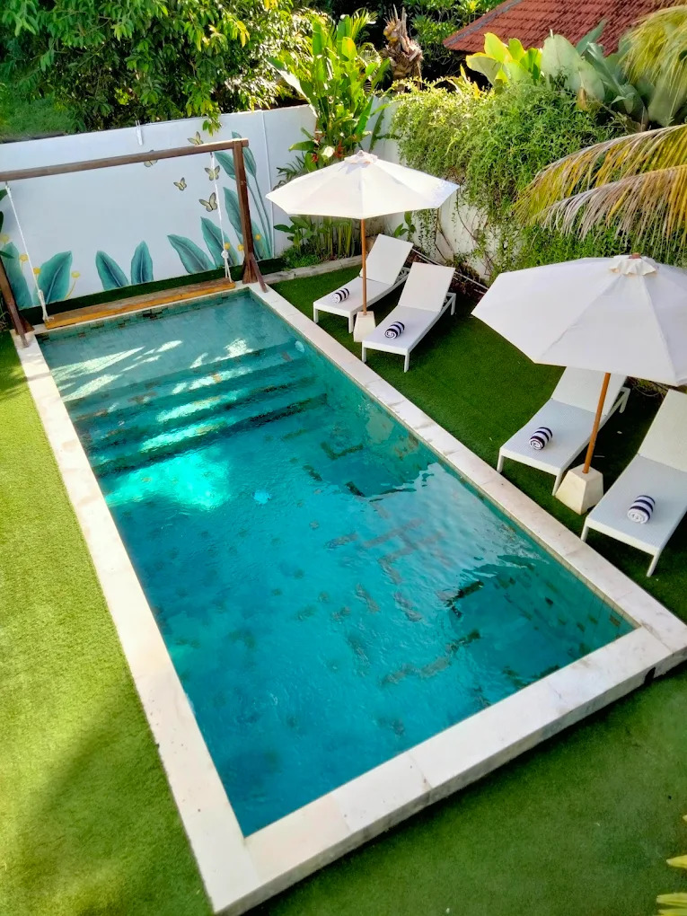 High angle view of the rectangular pool ringed by loungers and umbrellas